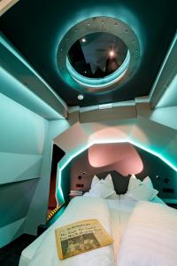a bedroom with a bed in a room with a round mirror at Apollo11 in Collepietra