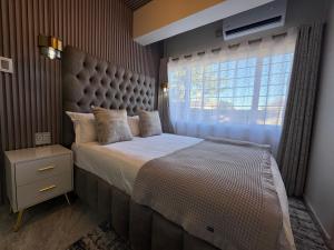 a bedroom with a large bed and a window at G - Boutique in Durban +48 photos