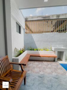 a patio with a bench and a table and stairs at Lakshani Villa in Polonnaruwa