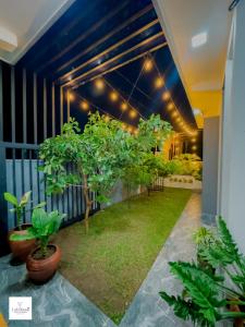 a courtyard with trees and lights in a building at Lakshani Villa in Polonnaruwa