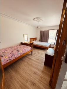 a bedroom with two beds and a window at Auckland Airport Guest House in Auckland