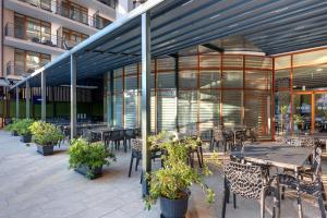 a patio with tables and chairs and a building at Best Western PLUS Premium Inn in Sunny Beach