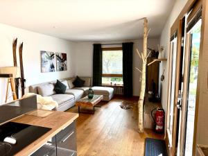 a living room with a couch and a table at Schliersee-Lounge in Schliersee