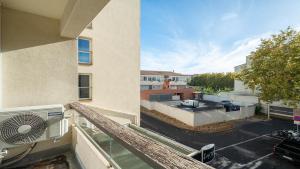 an apartment balcony with a view of a parking lot at Le St Clair N208 ST2 in Agde +4 photos