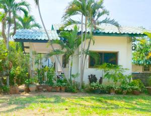 a house with a lot of plants in front of it at Samroiyod Holiday Resort in Sam Roi Yot