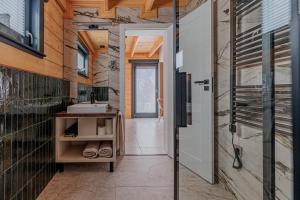 a bathroom with a sink and a mirror at Bükk Hill Garden in Miskolc