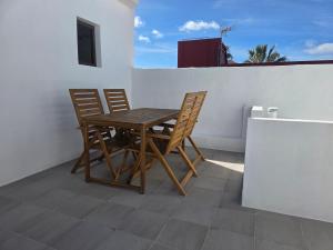 a wooden table and chairs sitting on a balcony at Casa Alvarez Tazacorte in Tazacorte