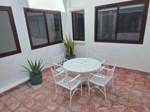a table and four chairs and a table and some windows at Casa Alvarez Tazacorte in Tazacorte