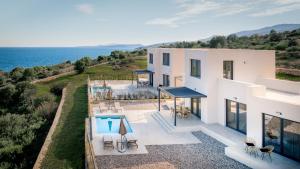an aerial view of a house with a swimming pool at Ventalia Villas, 3BR Sea View and Infinity Pool by Villa Mana Gers in Agios Nikolaos
