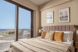 a bedroom with a bed and a large window at Ventalia Villas, 3BR Sea View and Infinity Pool by Villa Mana Gers in Agios Nikolaos