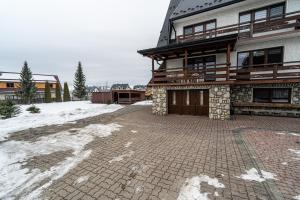 a building with a brick driveway in front of it at Dom Na Borku Józefa Schulz in Ciche