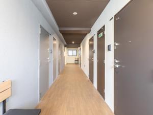 an empty corridor in an office building with a long hallway at Hotel Story Namba by Tabist in Osaka