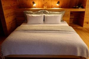 a bedroom with a bed with two pillows at Baglyos Vendégház Kulcs in Kulcs +43 photos