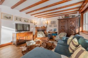 a living room with a couch and a tv at Chalet Ecureuil Family retreat w/ Garden & Fireplace - Happy Rentals in Chamonix
