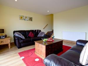 a living room with a couch and a coffee table at Beech Lodge - Retallack Resort in Saint Columb Major