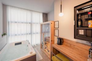 a bath tub in a room with a window at Boutique Casa Giulietta Luxury in Como