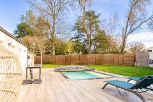 a backyard with a pool and a table and a chair at Nouveau ! Bulle d'air - Maison avec piscine in Bouaye