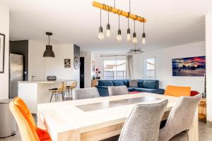 a kitchen and living room with a table and chairs at Nouveau ! Bulle d'air - Maison avec piscine in Bouaye +8 photos