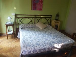 a bedroom with a bed with a blue comforter at La Camera Tra Gli Ulivi Dream Finale in Finale Ligure