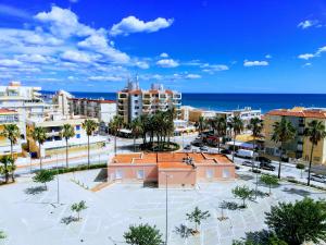 a city with buildings and the ocean in the background at Les Motes Solo Familias Serviplaya!!! in Playa de Xeraco