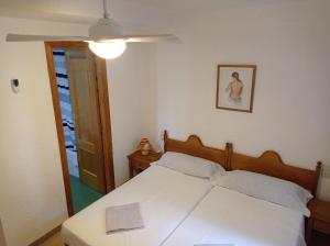 a bedroom with a white bed with a light on it at Deltamar Solo Familias Serviplaya in Xeraco +178 photos
