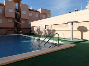 a swimming pool in the middle of a building at Oasis Solo Familias Serviplaya in Playa de Xeraco