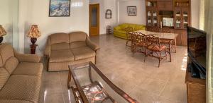a living room with a couch and a table at Maryvent Solo Familias Serviplaya in Playa de Xeraco