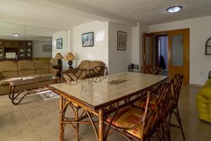 a living room with a table and chairs at Maryvent Solo Familias Serviplaya in Playa de Xeraco