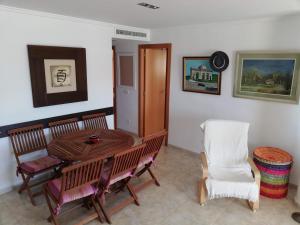 a dining room with a table and chairs at Mediterránea Solo Familias Serviplaya in Playa de Xeraco