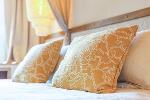 a bed with two pillows on top of it at La Maison Brevan in Châteaulin