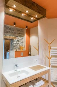 a bathroom with a sink and a mirror at La Maison Brevan in Châteaulin +48 photos