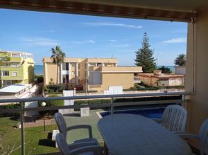 a view from a balcony with chairs and a swimming pool at Solmar II Solo Familias Serviplaya in Playa de Xeraco