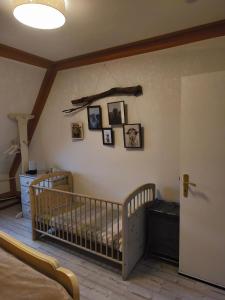 a nursery with a crib and pictures on the wall at Watt in Karolinenkoog