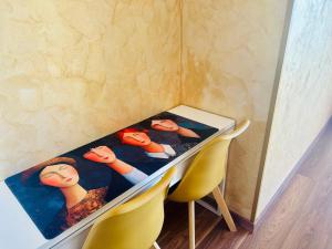 a table with three dolls sitting on top of it at BluMare ArtHouse in Salerno