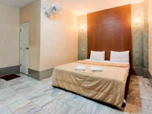 a bedroom with a large bed with two towels on it at Veerakit Grand Hotel Udon Thani in Udon Thani +16 photos