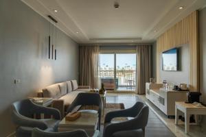 a living room with a couch and a table at Sunrise Crystal Bay Resort -Grand Select in Hurghada