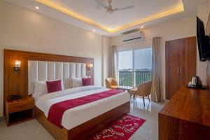 a bedroom with a large bed and a large window at HOTEL RAH INN - Yog Nagari Rishikesh Railway Station in Rishīkesh +31 photos