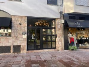 a store with a sign on the front of a building at Ventura 5 in Cangas de Onís