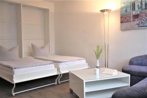 a living room with two beds and a table at Am Langenwerder Whg 4 in Gollwitz