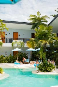 a group of people in a pool at a resort at Lay Day Hostel Uluwatu in Uluwatu
