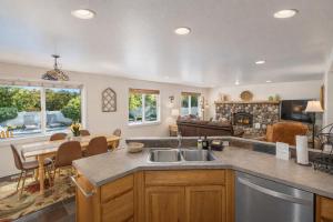 a kitchen with a sink and a living room at All Seasons Getaway in Leavenworth