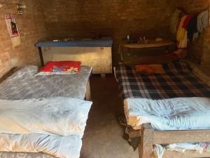 a room with two beds and a sink in it at Anurag singh homestay in Gaura Umarni