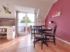 a dining room with a table and chairs at Ostseeliebe in Kirchdorf