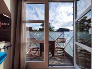 a balcony with a view of a table and chairs at Ostseeliebe in Kirchdorf