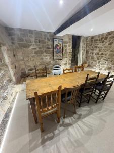 a dining room with a wooden table and chairs at Casa Brillantes Completa in Ayerbe
