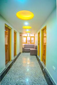 a living room with a couch and a yellow ceiling at Hotel Sahil - City Center, LalChowk in Srinagar
