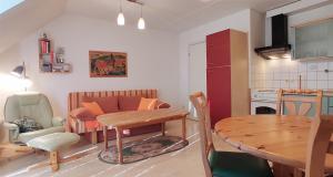 a kitchen and a living room with a table and a dining room at Apartment Pawelzig in Kirchdorf