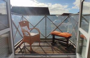 a balcony with a chair and a bench on the top at Apartment Pawelzig in Kirchdorf