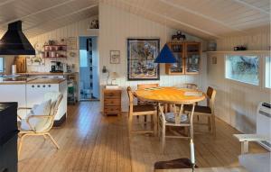 a kitchen and dining room with a table and chairs at Tziki in Fanø