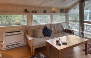 a living room with a couch and a table at Tziki in Fanø